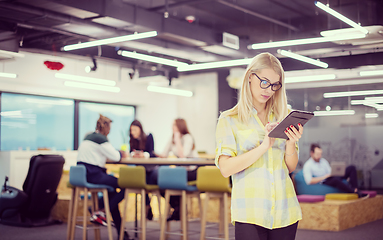 Image showing blonde businesswoman working online using digital tablet