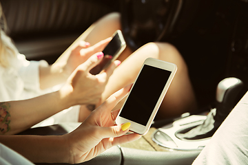 Image showing Young lesbian\'s couple preparing for vacation trip on the car in sunny day