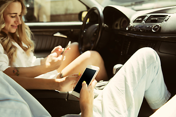 Image showing Young lesbian\'s couple preparing for vacation trip on the car in sunny day