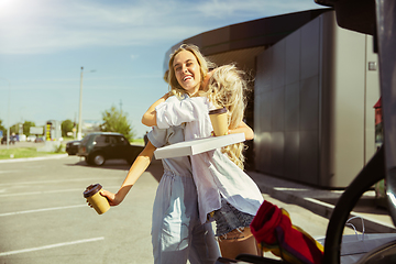 Image showing Young lesbian\'s couple preparing for vacation trip on the car in sunny day