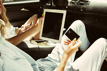 Image showing Young lesbian\'s couple preparing for vacation trip on the car in sunny day