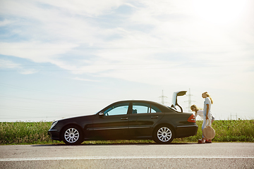 Image showing Young lesbian\'s couple going to vacation trip on the car in sunny day