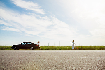 Image showing Young lesbian\'s couple going to vacation trip on the car in sunny day