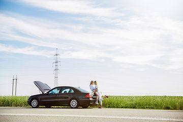 Image showing Young lesbian\'s couple going to vacation trip on the car in sunny day