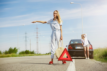 Image showing Young lesbian\'s couple going to vacation trip on the car in sunny day