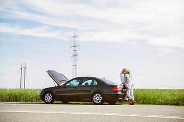 Image showing Young lesbian\'s couple going to vacation trip on the car in sunny day