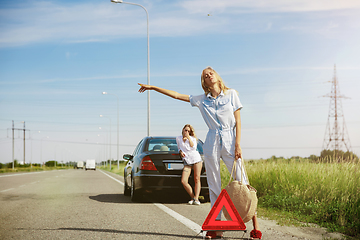 Image showing Young lesbian\'s couple going to vacation trip on the car in sunny day