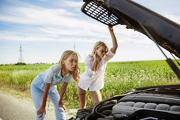 Image showing Young lesbian\'s couple going to vacation trip on the car in sunny day