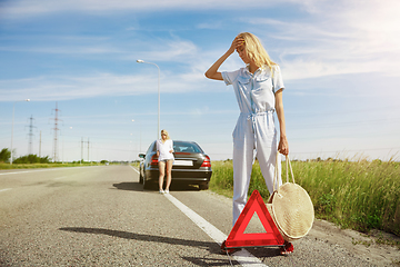 Image showing Young lesbian\'s couple going to vacation trip on the car in sunny day