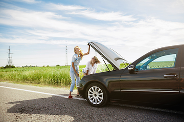 Image showing Young lesbian\'s couple going to vacation trip on the car in sunny day