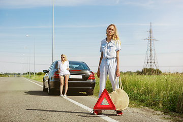 Image showing Young lesbian\'s couple going to vacation trip on the car in sunny day