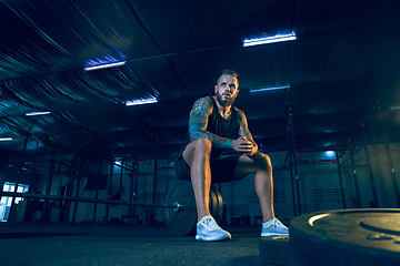 Image showing Young healthy man athlete preparing for training in the gym