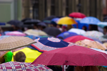 Image showing Crowd of people with umbrellas