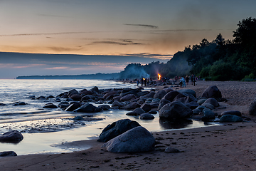 Image showing Unrecognisable people celebrating summer solstice with bonfires on beach