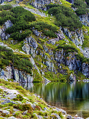 Image showing Mountain slope with small lake at botom