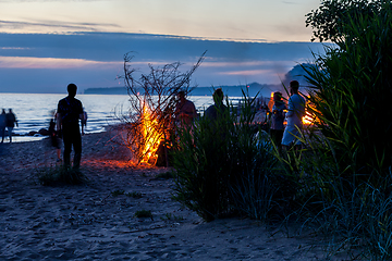 Image showing Unrecognisable people celebrating summer solstice with bonfires on beach