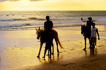 Image showing tourists riding horses on beach