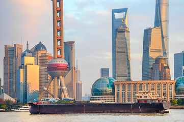 Image showing Barge by sunset Shanghai skyline