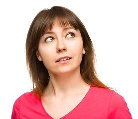 Image showing Young happy woman is looking up and smile