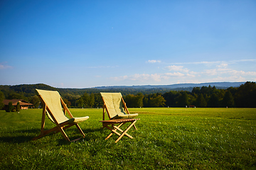 Image showing Relax with wooden chair and table. Enjoy the view of garden forest