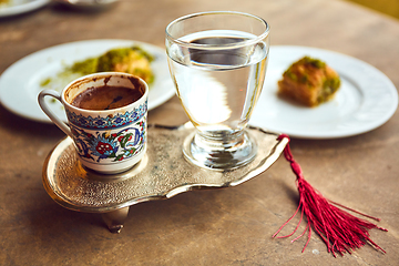 Image showing Turkish coffee and turkish delight with traditional embossed metal tray and cup
