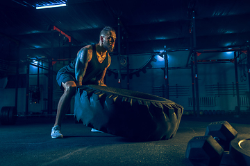 Image showing Young healthy man athlete doing exercise in the gym