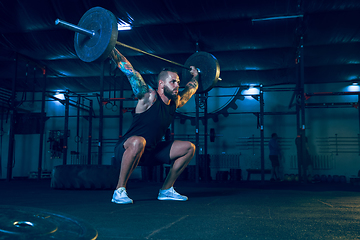 Image showing Young healthy man athlete doing exercise in the gym