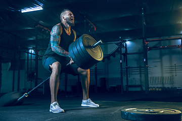 Image showing Young healthy man athlete doing exercise in the gym