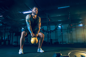 Image showing Young healthy man athlete doing exercise in the gym