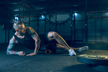 Image showing Young healthy man athlete doing exercise in the gym