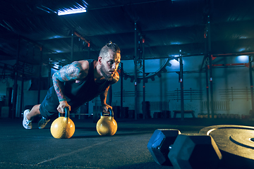 Image showing Young healthy man athlete doing exercise in the gym