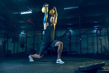 Image showing Young healthy man athlete doing exercise in the gym