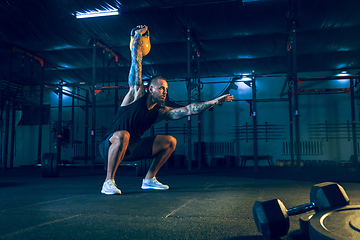 Image showing Young healthy man athlete doing exercise in the gym