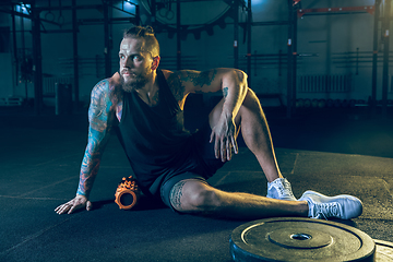 Image showing Young healthy man athlete doing exercise in the gym