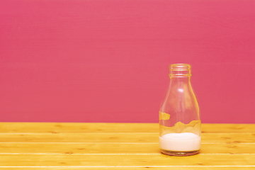 Image showing One-third pint milk bottle with dregs of strawberry milkshake