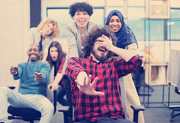 Image showing multiethnics business team racing on office chairs