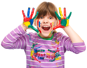 Image showing Portrait of a cute girl playing with paints