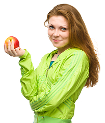 Image showing Young happy girl with apple