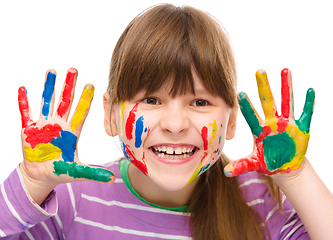 Image showing Portrait of a cute girl playing with paints