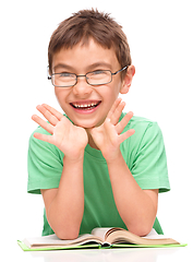 Image showing Little boy is reading a book