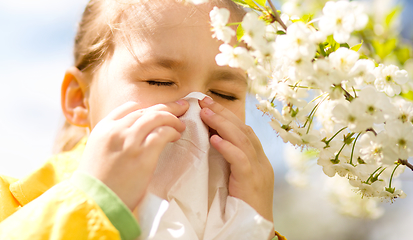 Image showing Little girl is blowing her nose