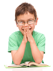 Image showing Little boy is reading a book