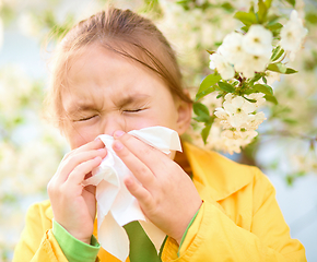 Image showing Little girl is blowing her nose