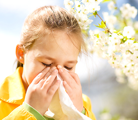 Image showing Little girl is blowing her nose