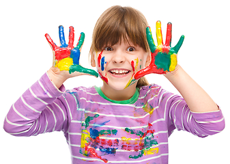 Image showing Portrait of a cute girl playing with paints