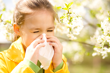 Image showing Little girl is blowing her nose