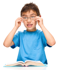 Image showing Little boy is reading a book