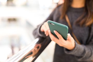 Image showing Woman sending sms on mobile phone