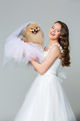 Image showing beautiful bride girl with spitz bride on gray background