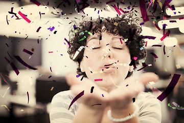 Image showing female software developer blowing confetti